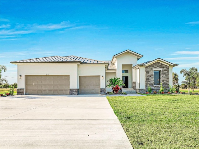 view of front of property with a front yard and a garage