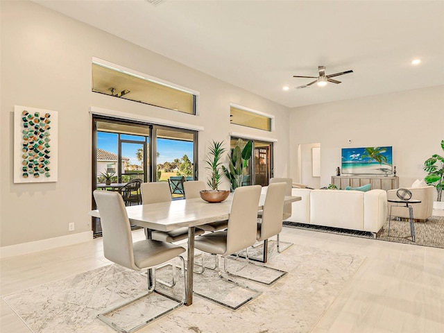 tiled dining space with ceiling fan