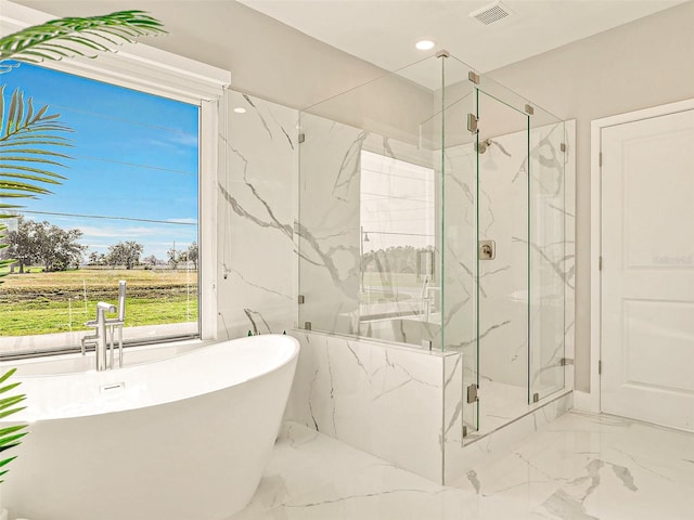 bathroom featuring shower with separate bathtub