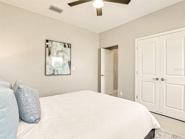 bedroom with a closet, ceiling fan, and light wood-type flooring