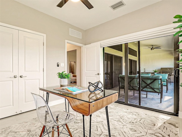 office area with light hardwood / wood-style flooring and ceiling fan