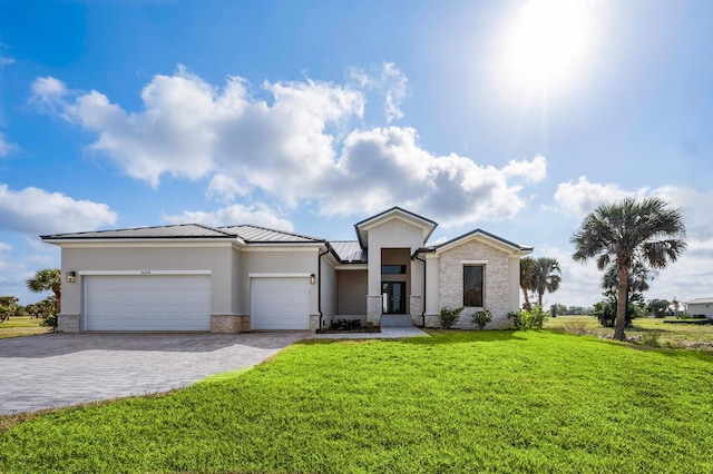 view of front of property with a garage and a front lawn