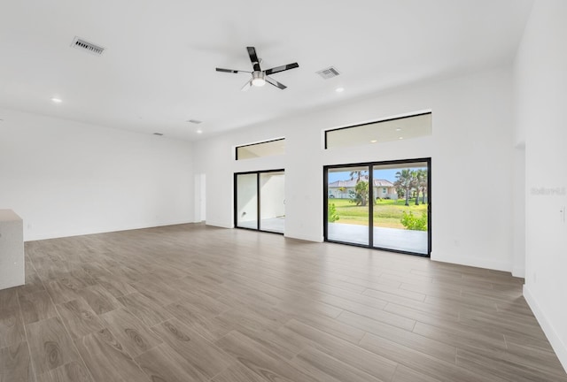 spare room with ceiling fan and light wood-type flooring