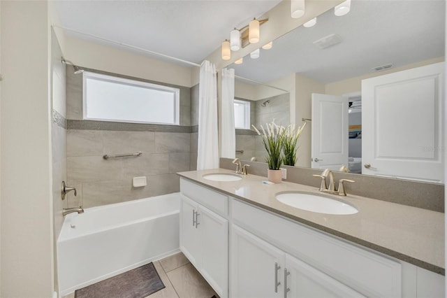 bathroom featuring vanity, tile patterned floors, and shower / bath combo