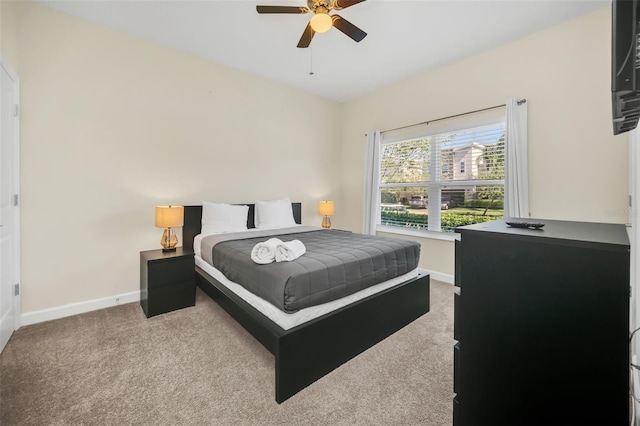 bedroom with ceiling fan and light colored carpet