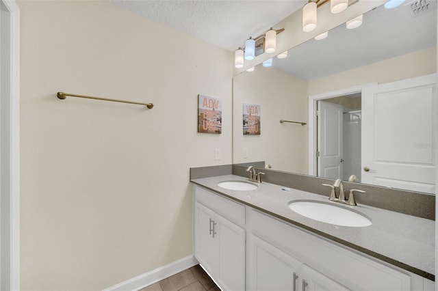 bathroom with vanity and a textured ceiling