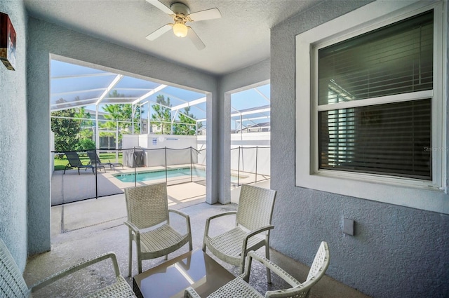 sunroom featuring ceiling fan, lofted ceiling, and a pool