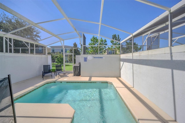 view of pool featuring a patio area and glass enclosure