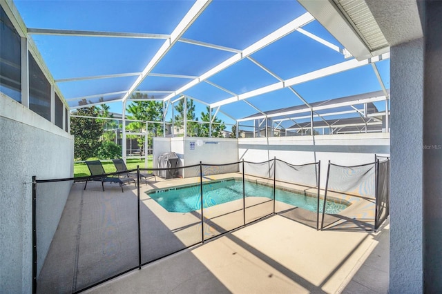 view of swimming pool with a patio area and a lanai