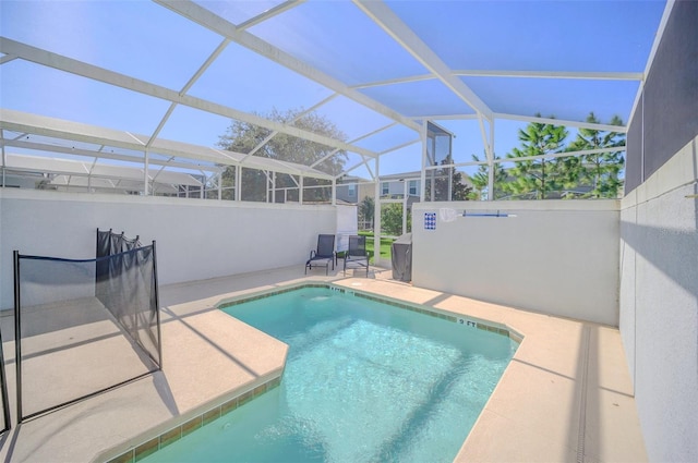 view of pool with a patio area and glass enclosure