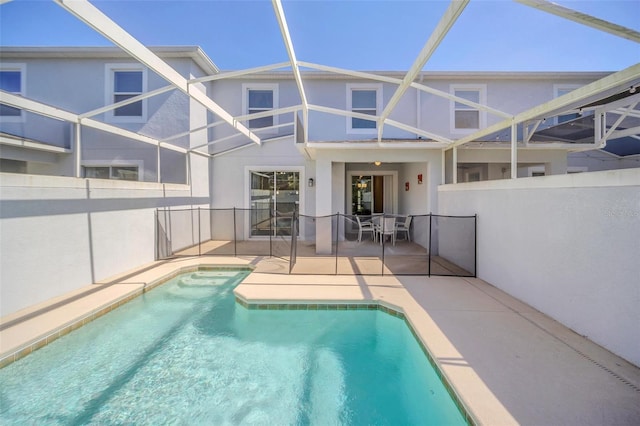 view of pool with a patio area and a lanai