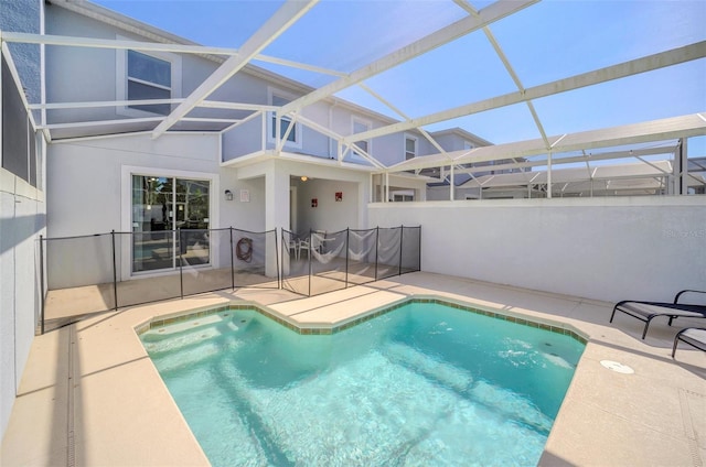 view of pool featuring a patio and glass enclosure