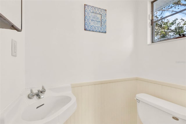 504 Osceola Ave, Eustis, FL 32726 - bathroom with a sink, toilet, and wainscoting