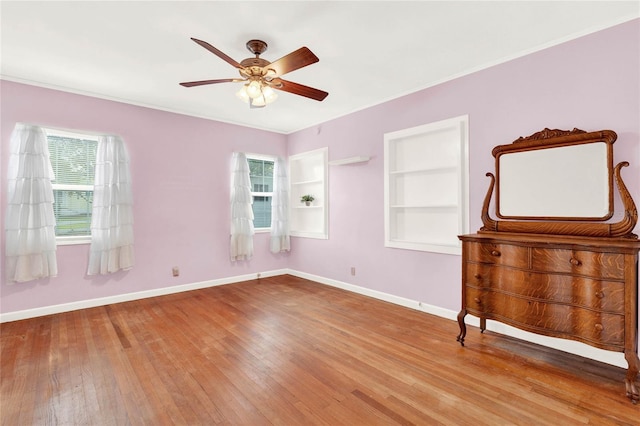 unfurnished bedroom featuring ceiling fan, light hardwood / wood-style floors, and multiple windows