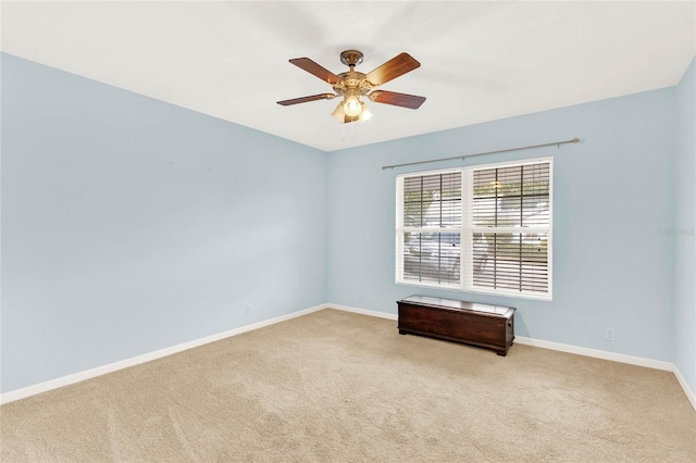 empty room featuring light colored carpet and ceiling fan