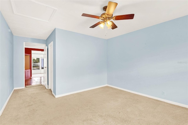 spare room with ceiling fan and light colored carpet