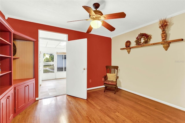 unfurnished room featuring crown molding, ceiling fan, and light hardwood / wood-style floors