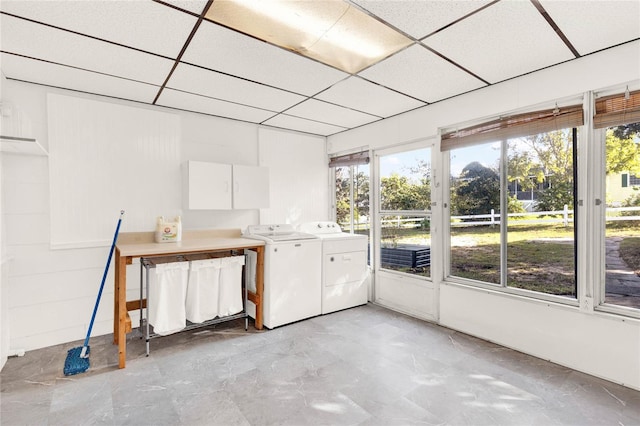 unfurnished sunroom with washer and dryer and a drop ceiling