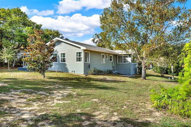 back of property featuring a lawn