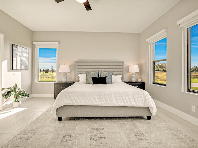 tiled bedroom featuring ceiling fan