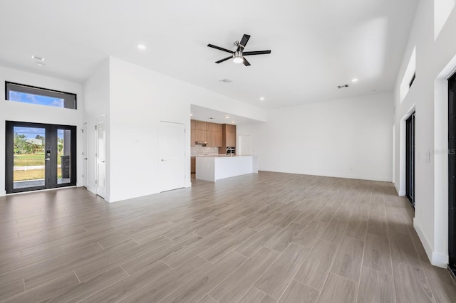 unfurnished living room with light hardwood / wood-style floors and ceiling fan