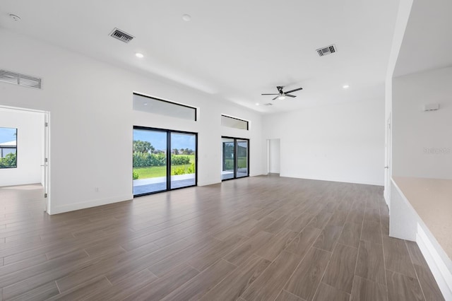 unfurnished living room featuring ceiling fan and hardwood / wood-style floors