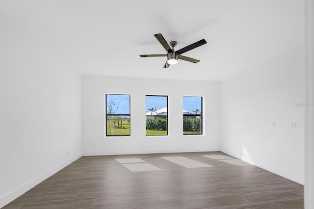 spare room featuring hardwood / wood-style floors and ceiling fan