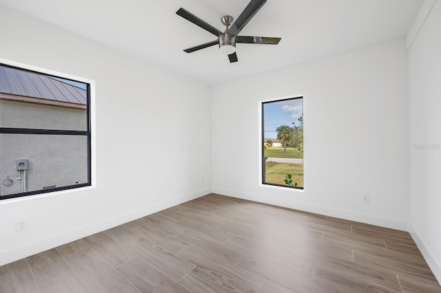 spare room featuring ceiling fan and light wood-type flooring