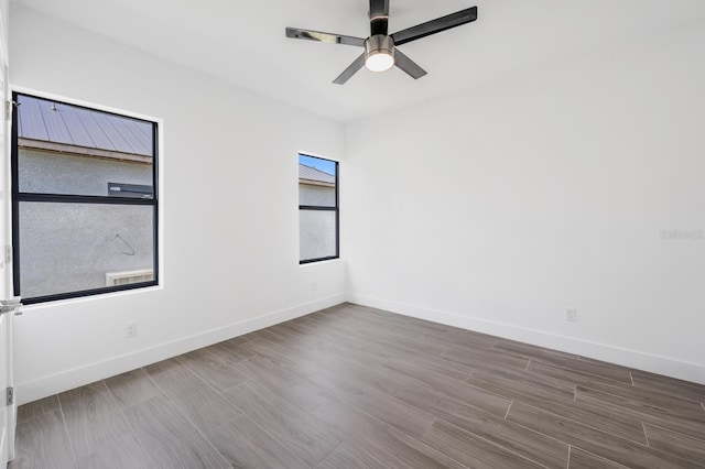 spare room featuring hardwood / wood-style flooring and ceiling fan