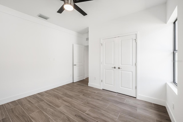 unfurnished bedroom featuring a closet and ceiling fan