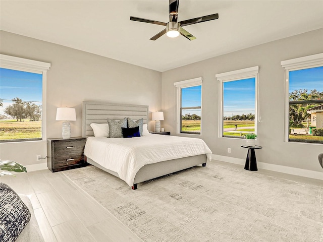 bedroom featuring multiple windows and ceiling fan