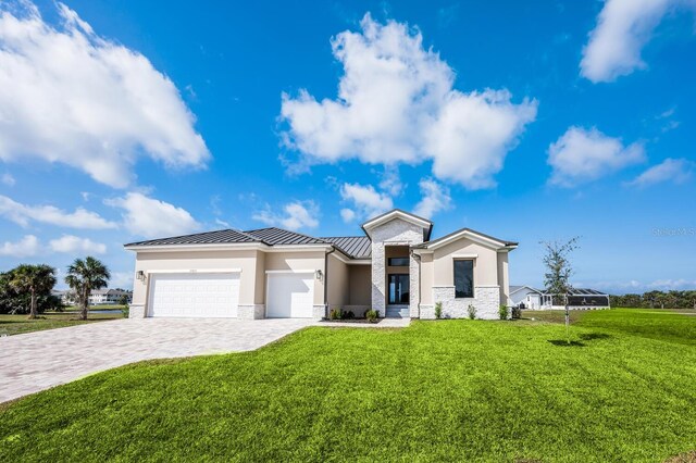 view of front of property featuring a garage and a front lawn