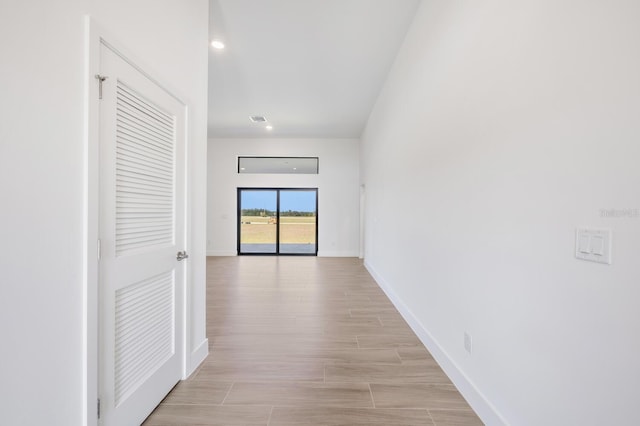 hall with light hardwood / wood-style flooring