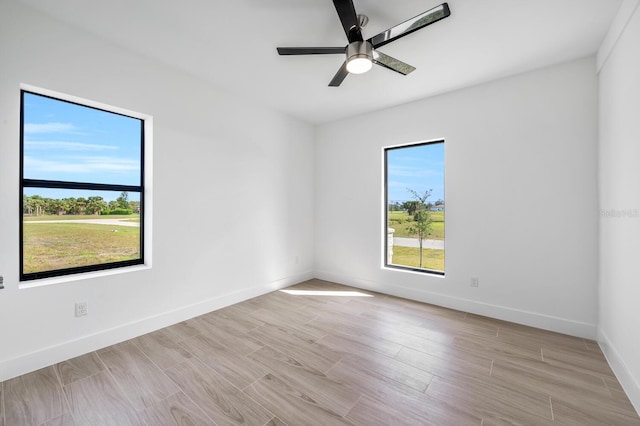 unfurnished room featuring light hardwood / wood-style flooring and ceiling fan