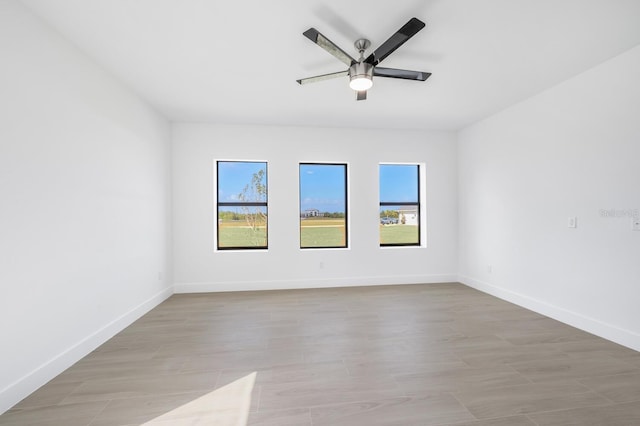 unfurnished room featuring a wealth of natural light and ceiling fan