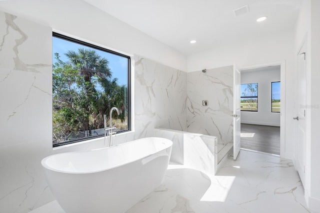 bathroom featuring separate shower and tub