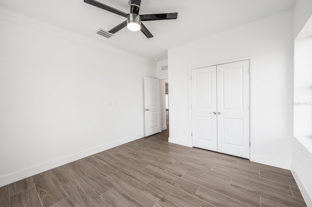 unfurnished bedroom with a closet and ceiling fan