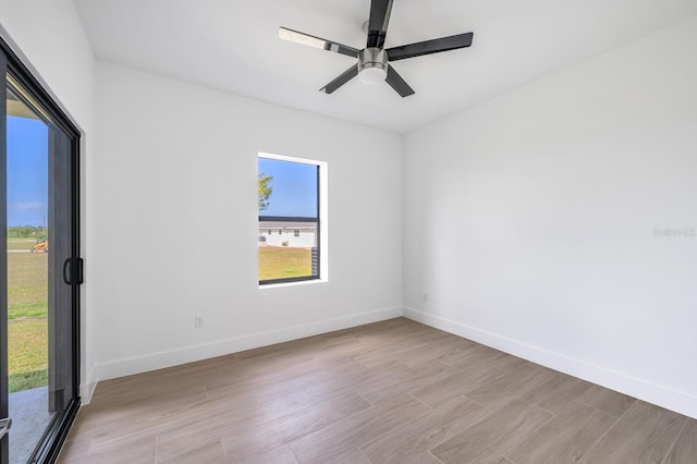 empty room featuring ceiling fan and light wood-type flooring