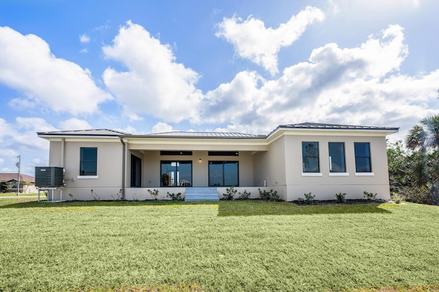 back of property featuring a yard and cooling unit