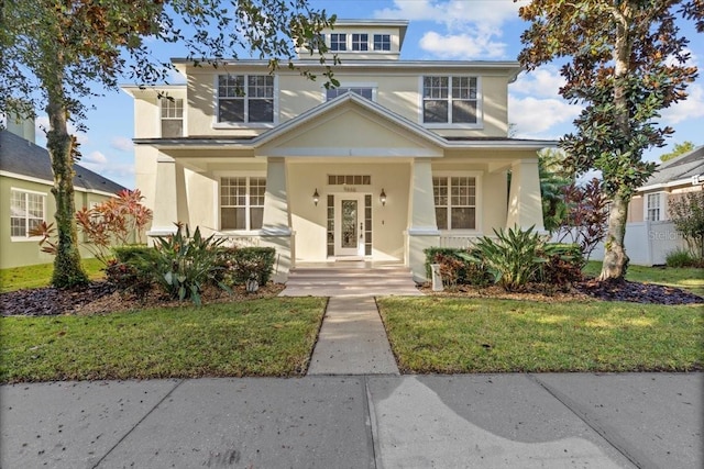 view of front of home with a front lawn and covered porch