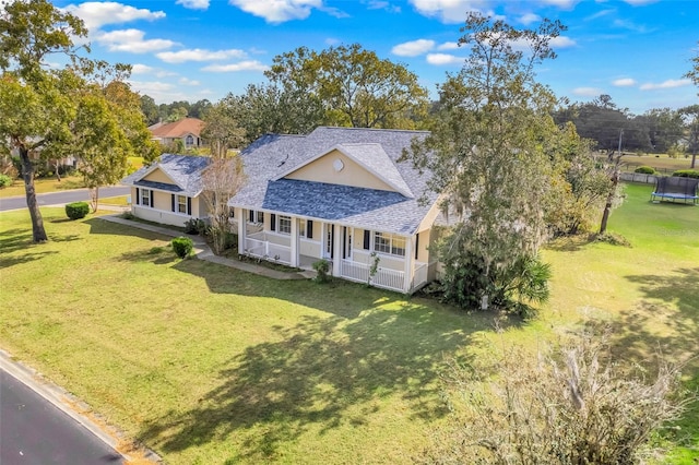 view of front of property featuring covered porch and a front lawn