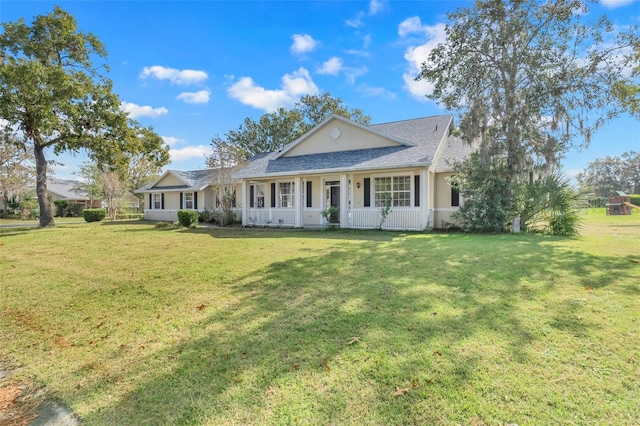 ranch-style home with covered porch and a front yard