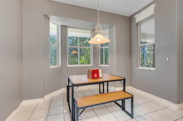 dining space featuring light tile patterned floors