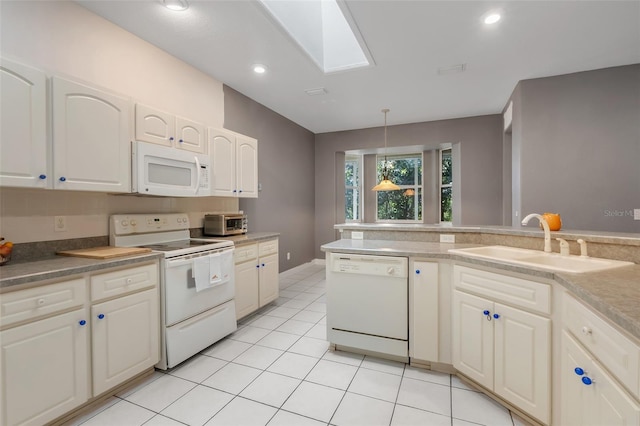 kitchen with white appliances, a skylight, sink, pendant lighting, and light tile patterned floors