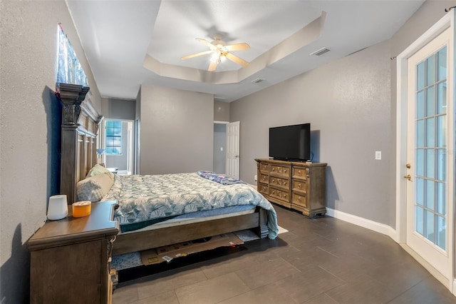 bedroom featuring ceiling fan and a raised ceiling