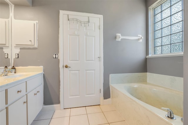 bathroom featuring vanity, tile patterned floors, and a bath