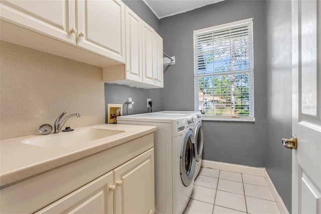 washroom with light tile patterned flooring, cabinets, sink, and separate washer and dryer