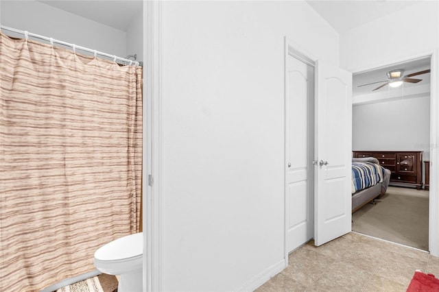 bathroom featuring toilet and ceiling fan