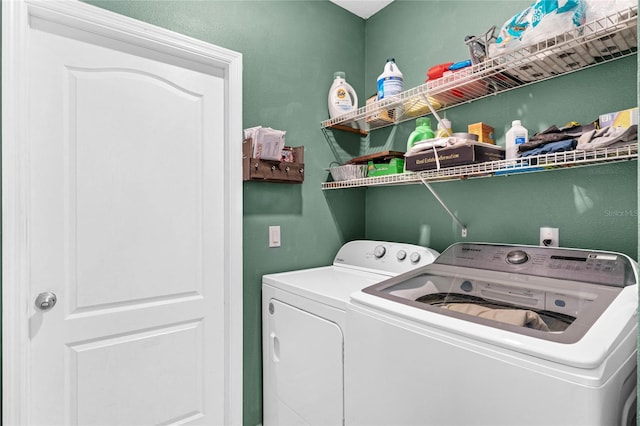 laundry area with washing machine and clothes dryer