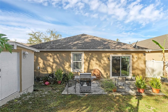 back of house featuring a patio and a yard